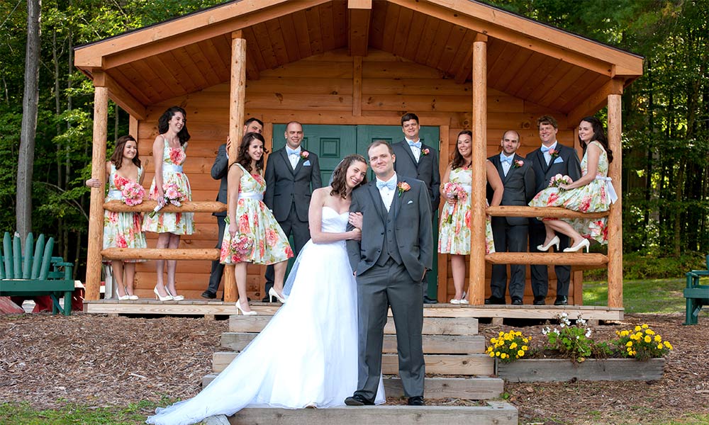 Wedding party outside a cabin