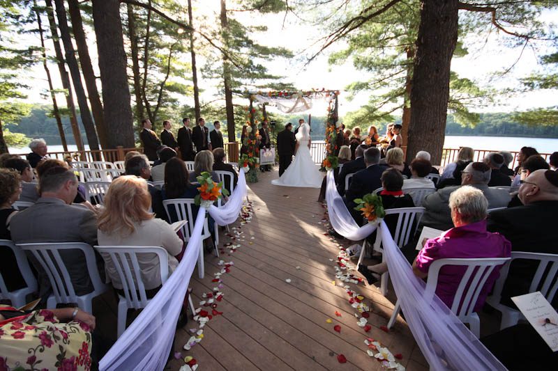 Outdoor ceremony on deck by a lake