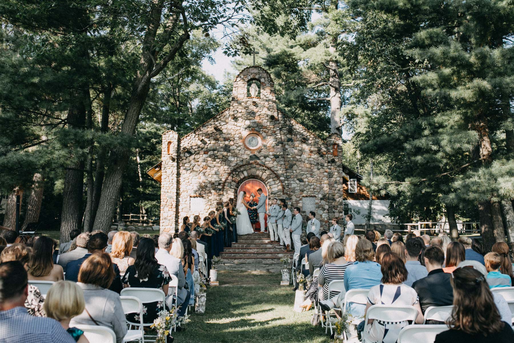 Ceremony outside stone chapel
