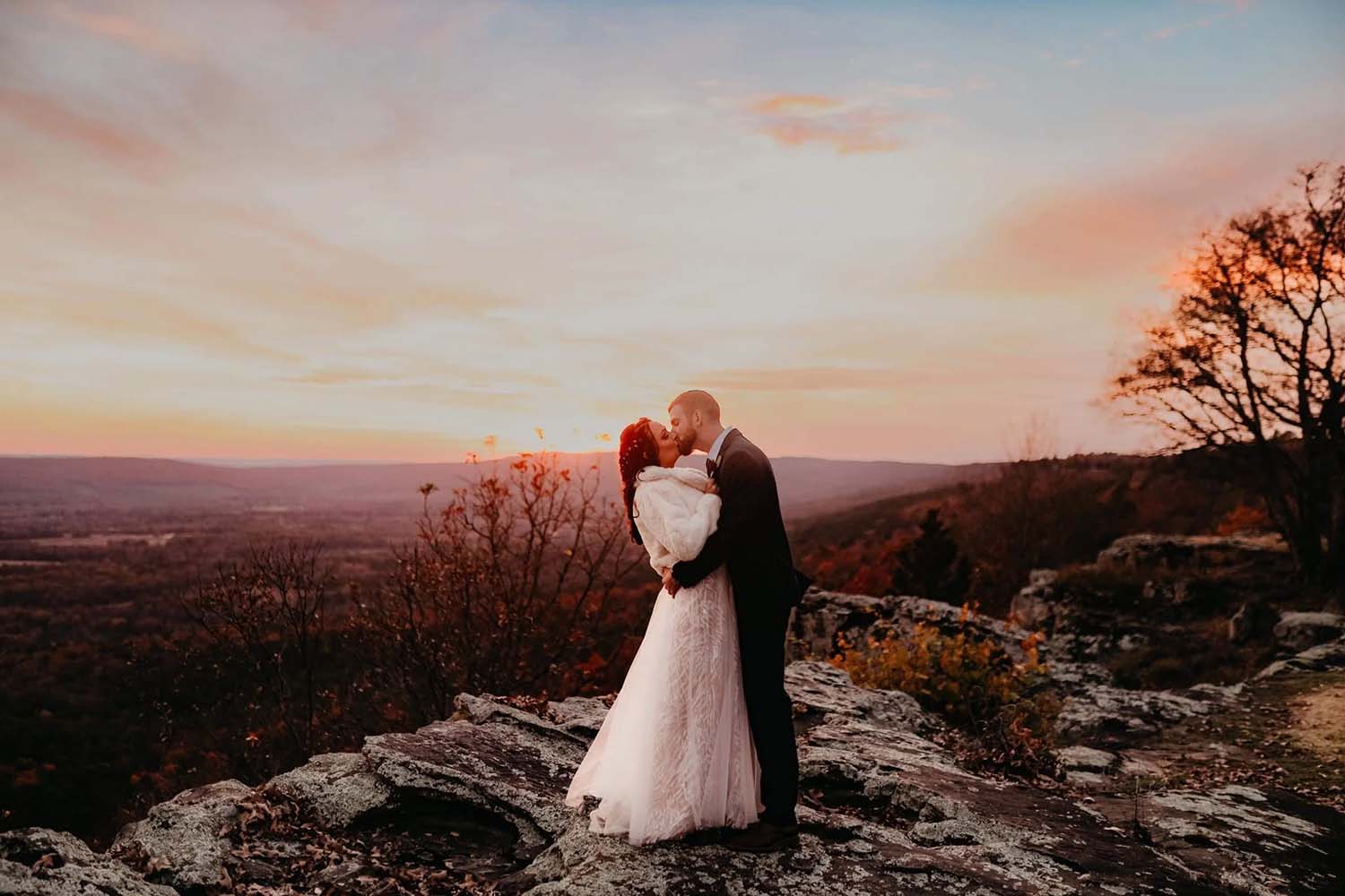 Bride and groom embracing near sunset