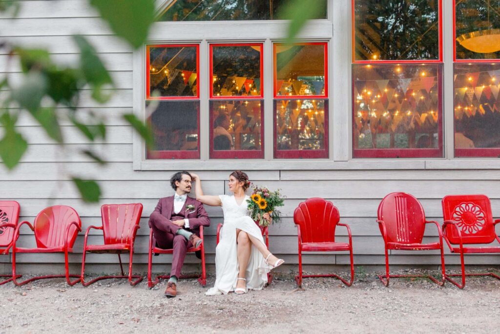 Bride and groom in colorful red chairs