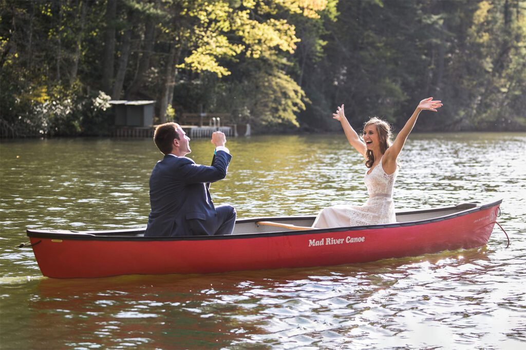 Bride and groom paddling in a canoe