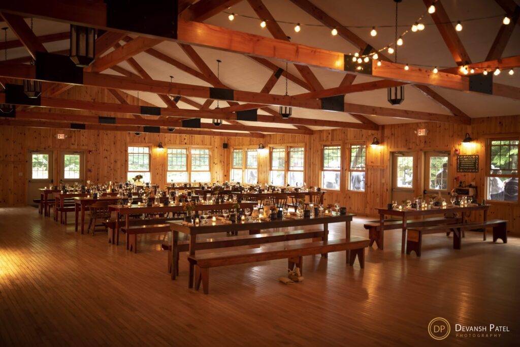 Reception tables set up in rustic dinning hall.