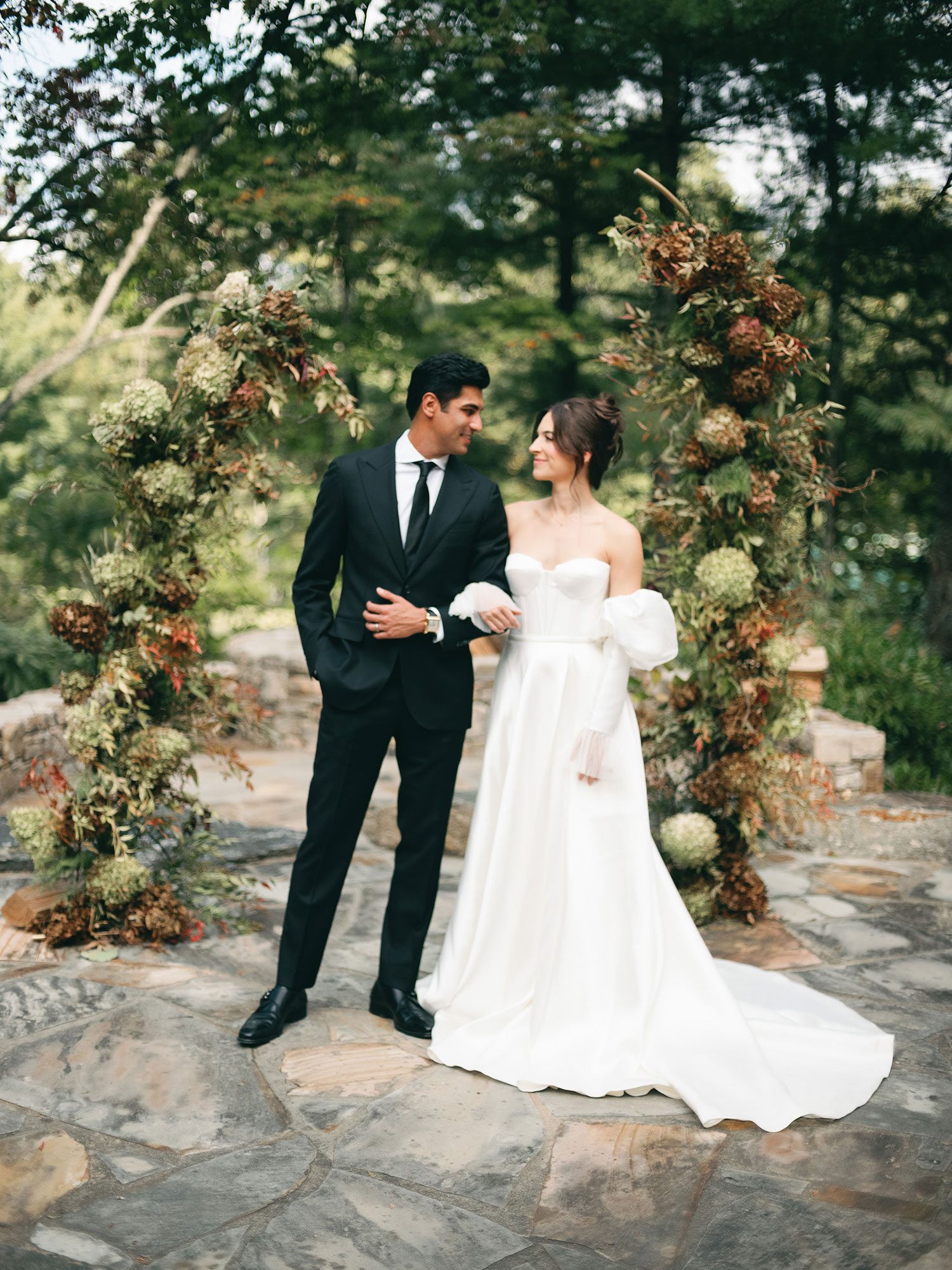 Bride and groom at wedding arch