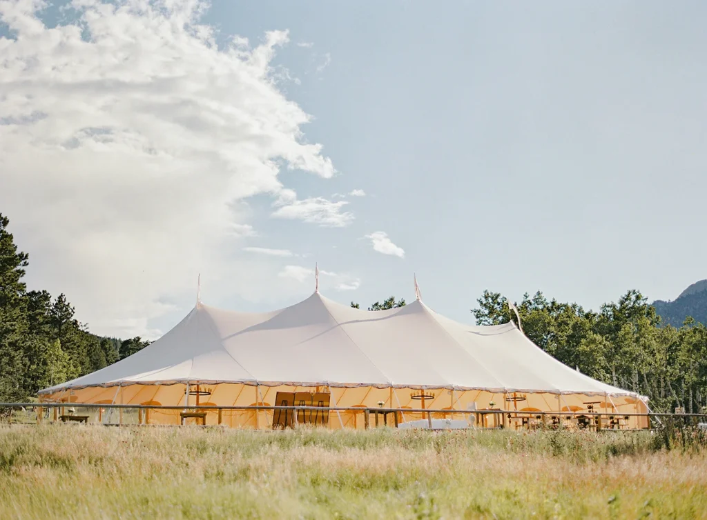 Outdoor reception tent on mountain meadow