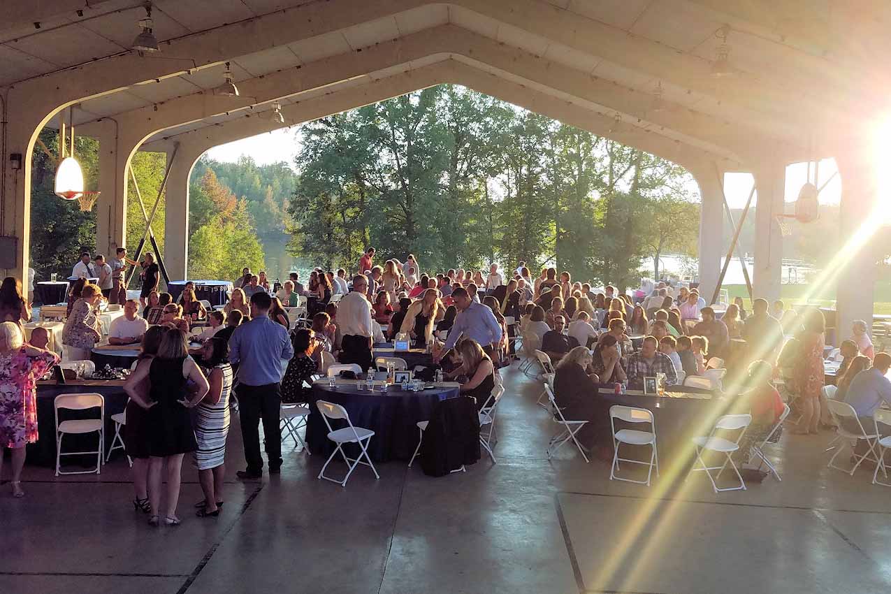 Reception at a large outdoor pavilion during sunet.