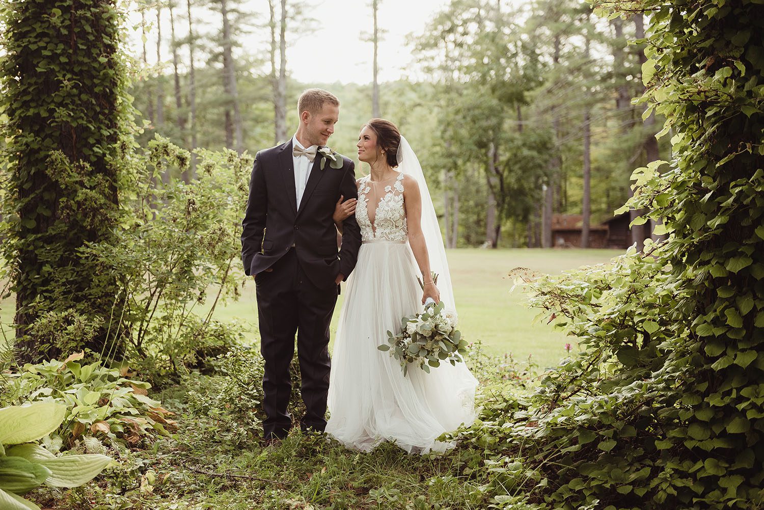 Bride and groom in lush camp setting