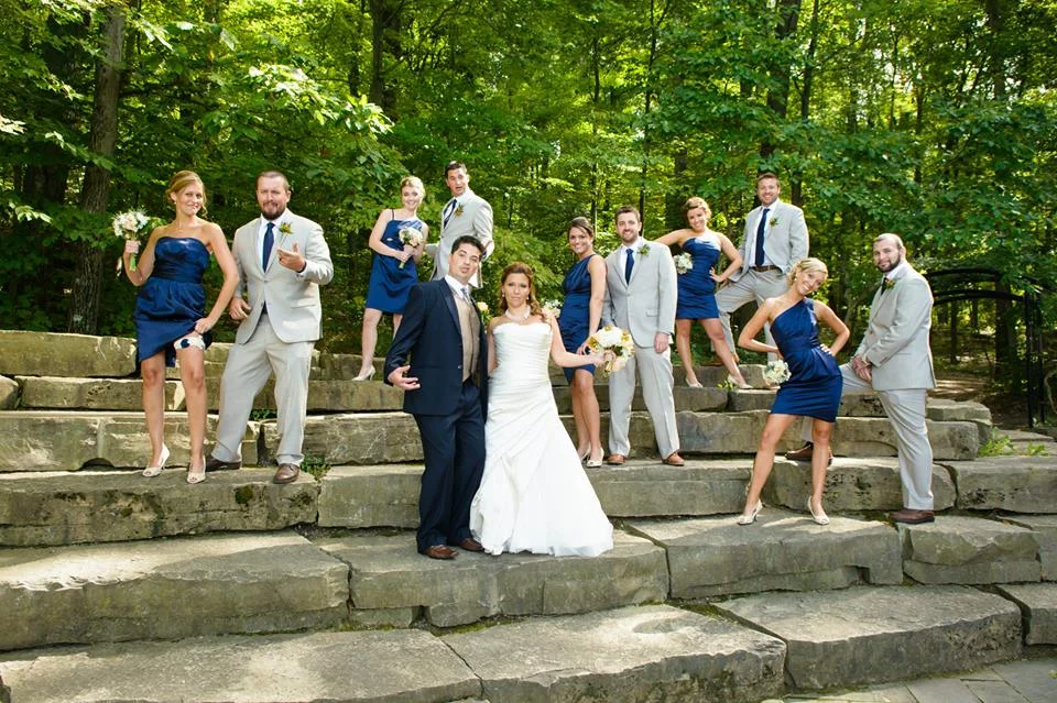 Wedding party posing on stone amphitheater