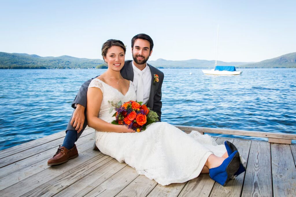 Bride and groom on lakeside dock