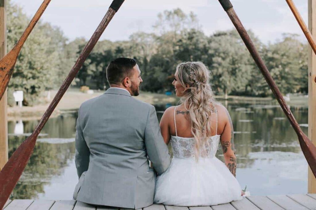 Couple sitting on dock looking at each other